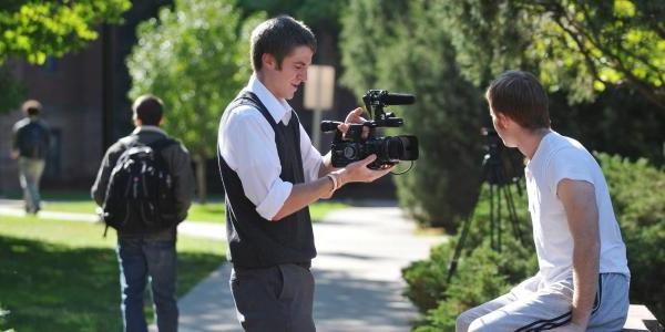 Student filming a student on campus